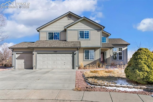 view of front of property featuring driveway, a garage, and roof with shingles