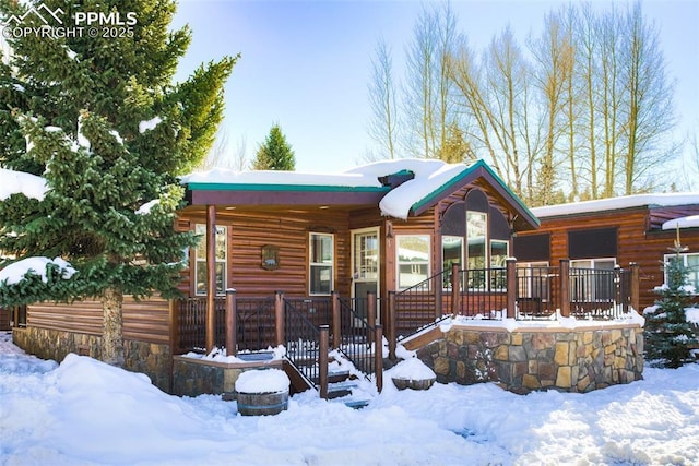 log cabin featuring a porch