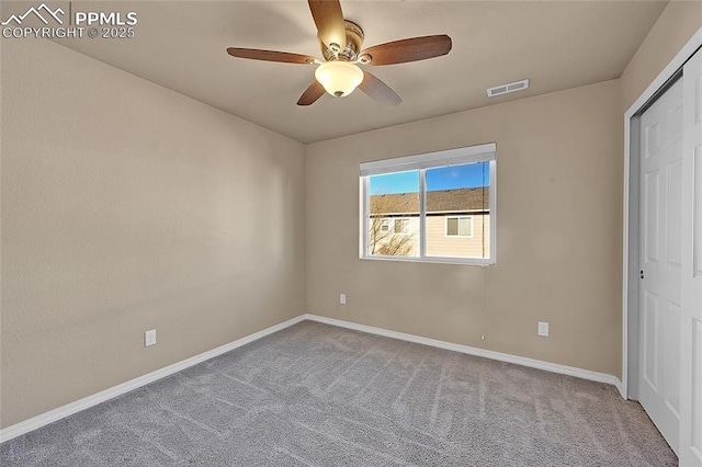 unfurnished bedroom featuring ceiling fan, a closet, and light carpet