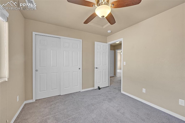 unfurnished bedroom featuring light colored carpet, a closet, and ceiling fan