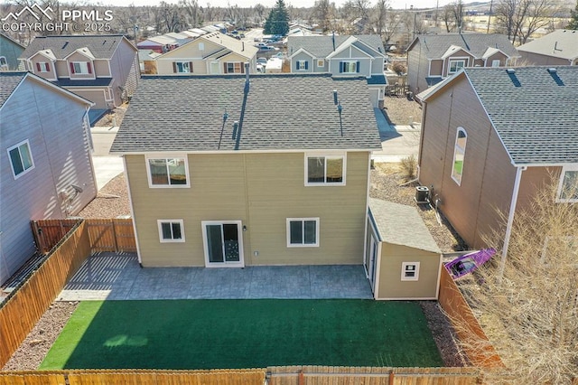 rear view of house with a patio and a yard