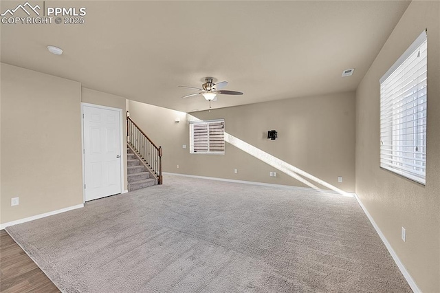 unfurnished living room with ceiling fan and carpet flooring