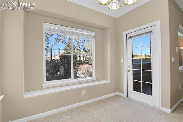 entryway with a wealth of natural light, ornamental molding, light colored carpet, and a notable chandelier