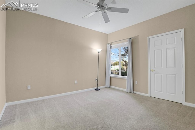 carpeted spare room featuring ceiling fan