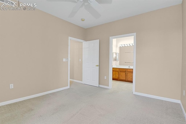 unfurnished bedroom with ceiling fan, light carpet, and ensuite bath