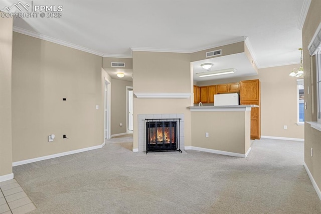 unfurnished living room with ornamental molding, light carpet, and a fireplace