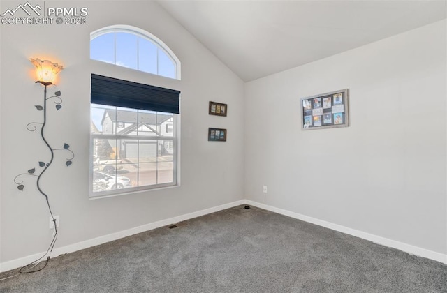 carpeted spare room featuring lofted ceiling