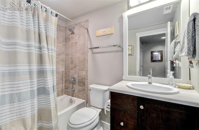 full bathroom featuring vanity, shower / bath combination with curtain, and toilet