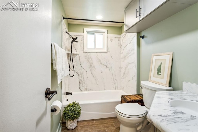 full bathroom featuring vanity, tiled shower / bath, and toilet