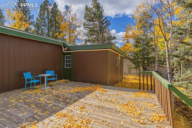 wooden terrace featuring a storage unit