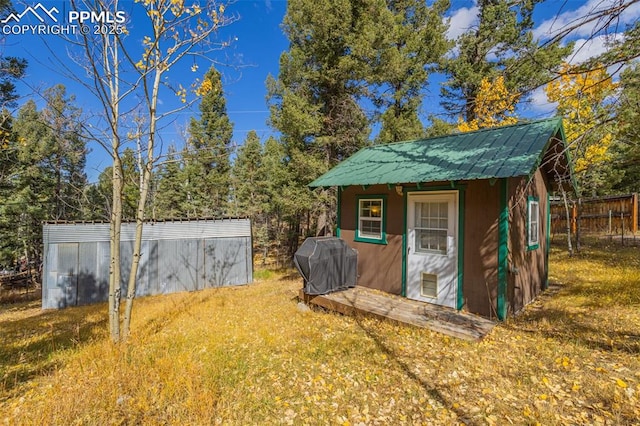 view of outbuilding featuring a yard