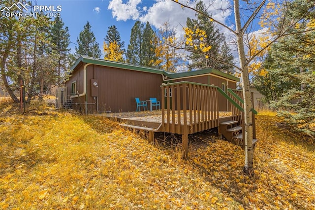 rear view of house featuring a deck