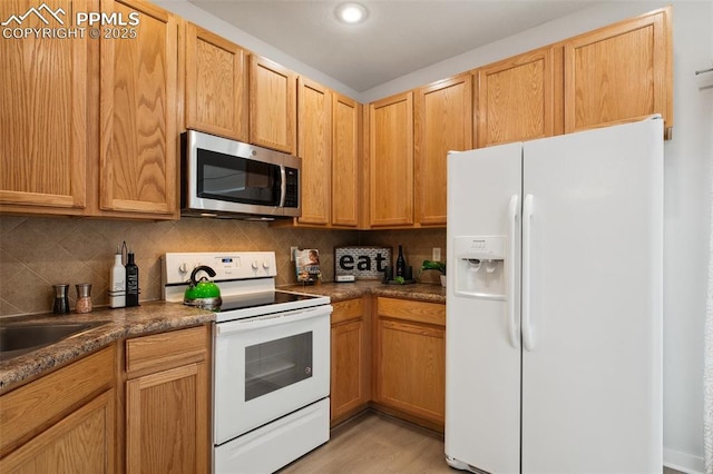 kitchen with white appliances and backsplash