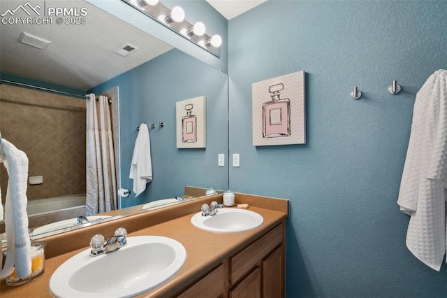 bathroom featuring vanity and shower / bath combination with curtain