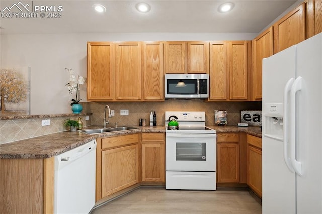 kitchen featuring light wood-type flooring, sink, white appliances, and decorative backsplash