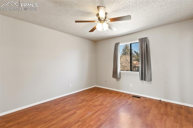 unfurnished room with hardwood / wood-style flooring, a textured ceiling, and ceiling fan