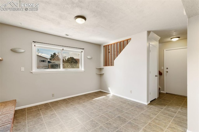 empty room with a textured ceiling