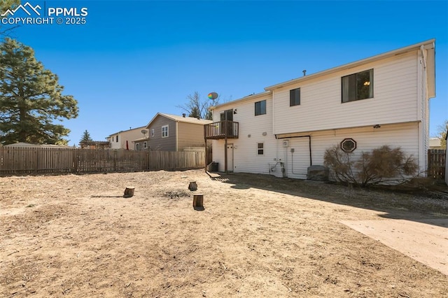 rear view of property featuring a balcony