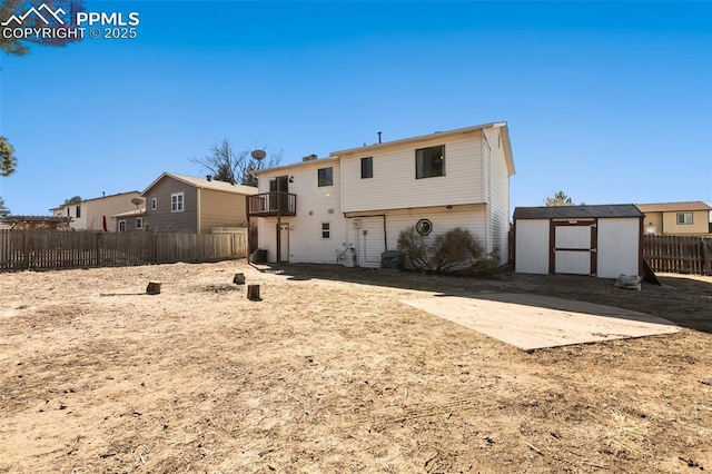 rear view of house with a balcony and a storage unit