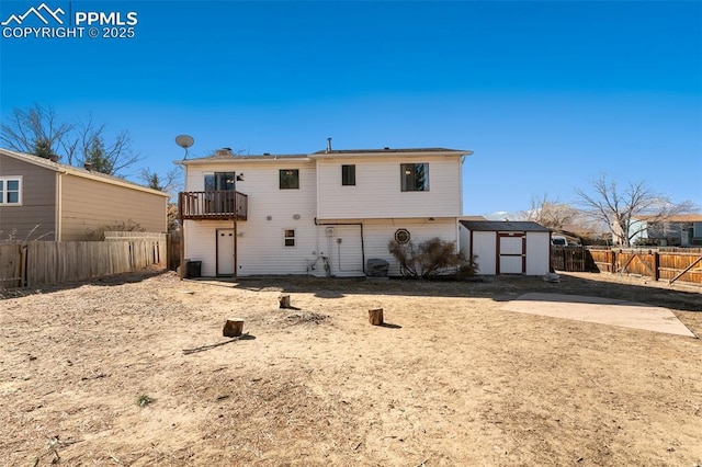 rear view of property featuring a balcony, central AC, and a shed