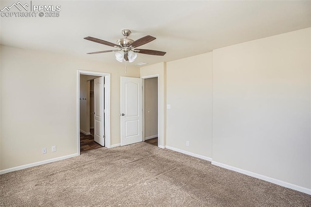 carpeted spare room with ceiling fan and baseboards