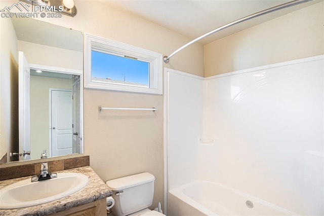 full bath featuring washtub / shower combination, vanity, and toilet