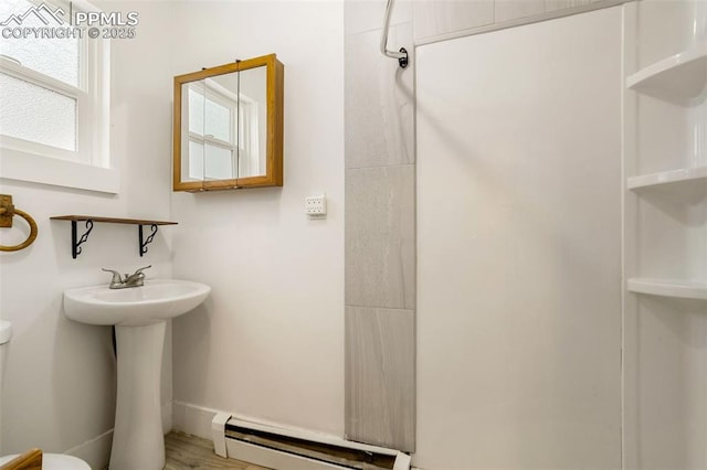 full bath with a baseboard radiator, walk in shower, and toilet