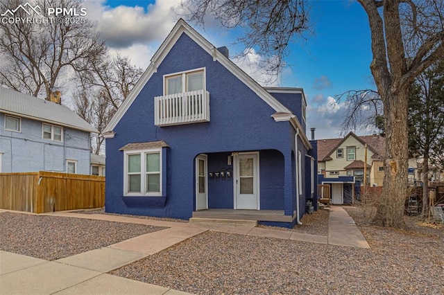 view of front of property with fence and stucco siding