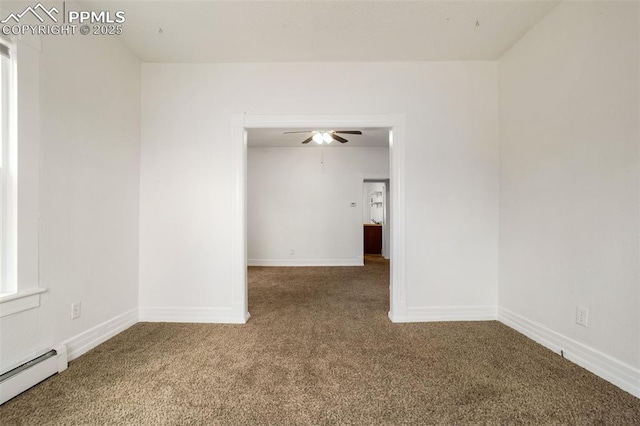 carpeted spare room featuring a ceiling fan, baseboards, and baseboard heating