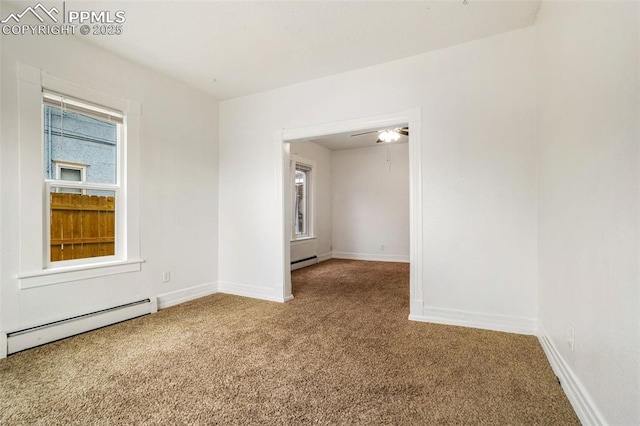 unfurnished room featuring baseboards, carpet flooring, and baseboard heating