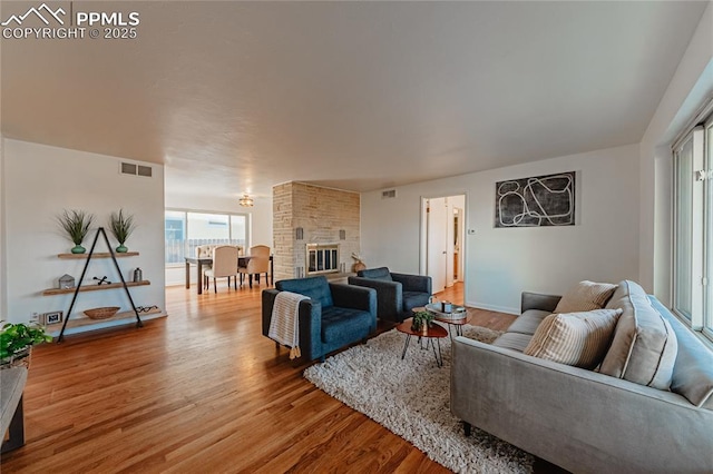 living room featuring hardwood / wood-style flooring and a fireplace