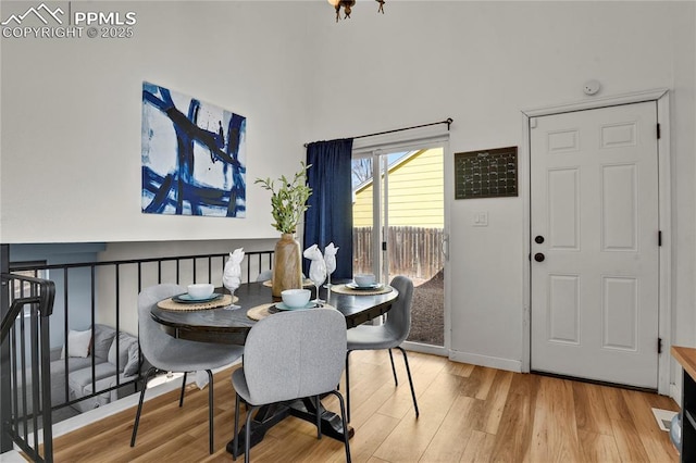 dining space featuring baseboards and wood finished floors