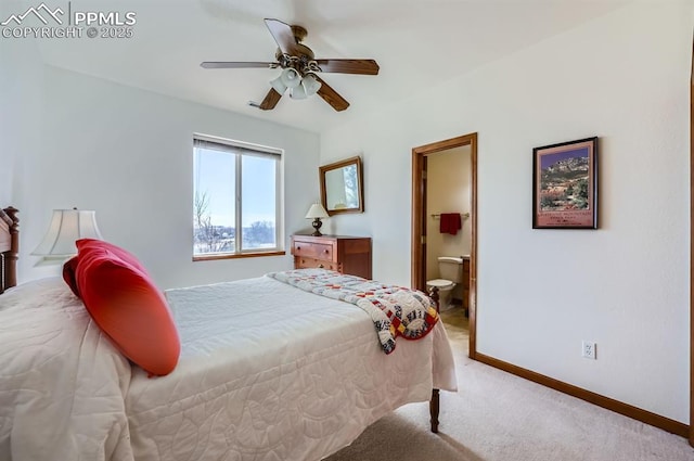 bedroom with carpet floors, ensuite bath, baseboards, and a ceiling fan