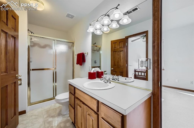 bathroom featuring visible vents, toilet, a shower stall, and vanity