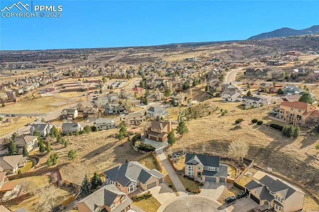 birds eye view of property with a mountain view and a residential view