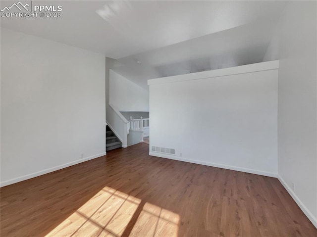 spare room with dark hardwood / wood-style flooring