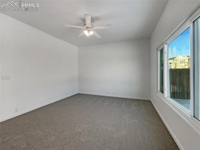 unfurnished room with ceiling fan and dark colored carpet