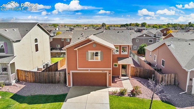 view of front of property featuring a garage and a front yard