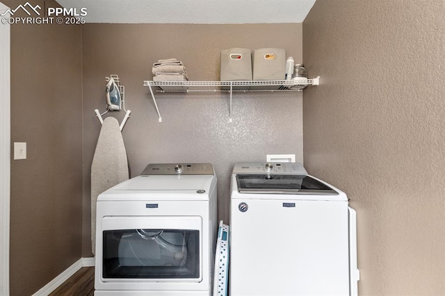 clothes washing area with dark hardwood / wood-style floors and separate washer and dryer