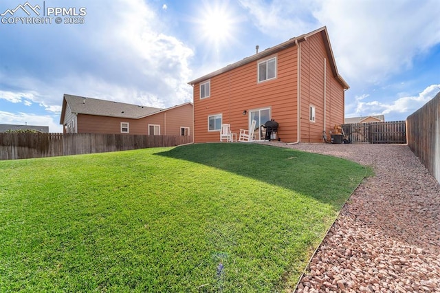 rear view of house featuring a lawn