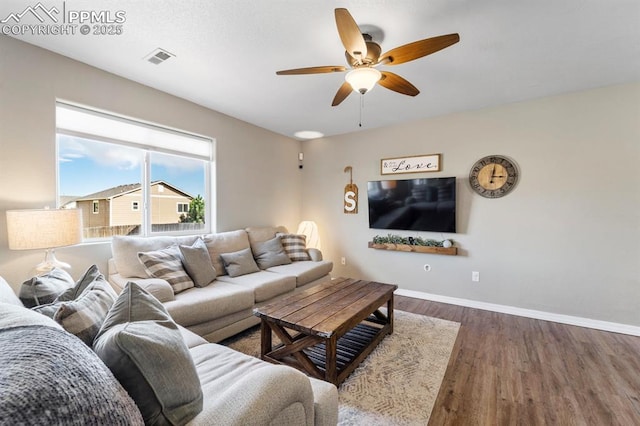 living room with dark hardwood / wood-style floors and ceiling fan