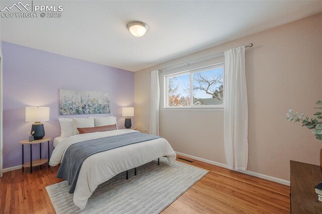 bedroom with hardwood / wood-style flooring