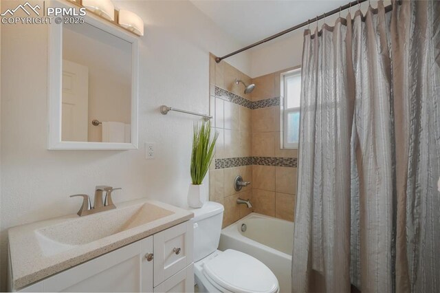 full bathroom featuring vanity, toilet, and shower / bathtub combination with curtain