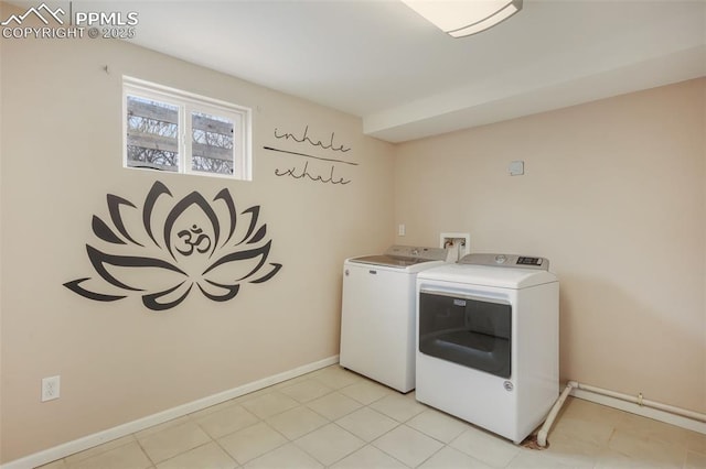 clothes washing area with separate washer and dryer and light tile patterned floors