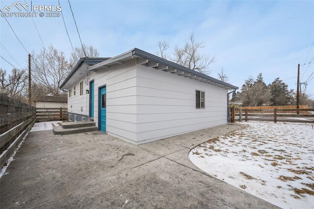 view of snow covered exterior featuring a patio