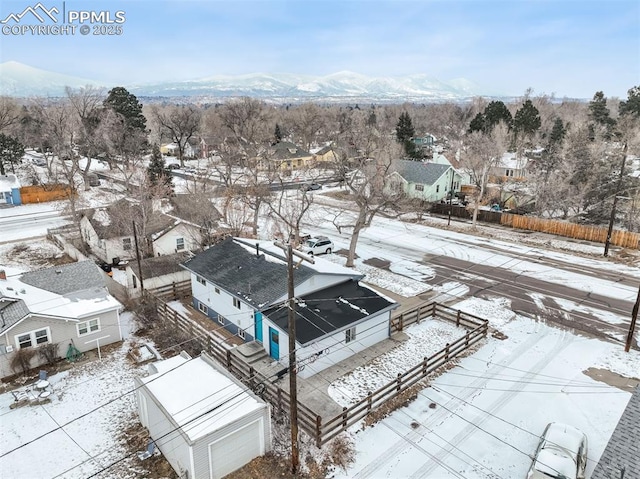 snowy aerial view with a mountain view