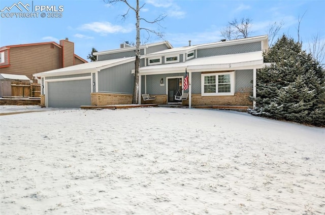 view of front of house featuring a garage and a porch