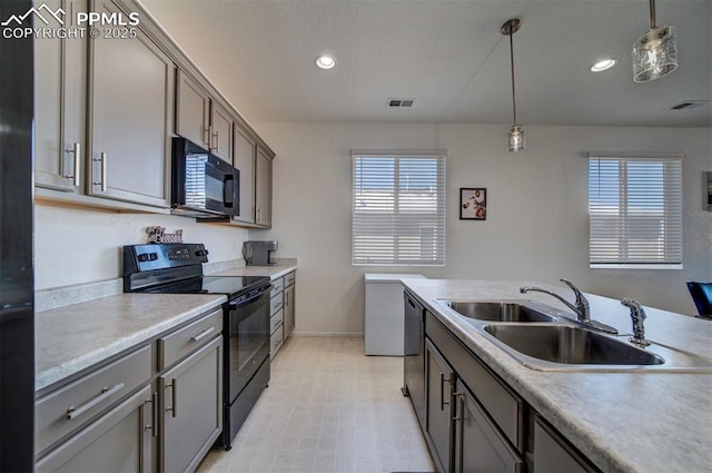 kitchen with hanging light fixtures, sink, and black appliances