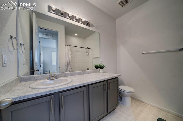 bathroom featuring vanity, a shower with shower curtain, and toilet