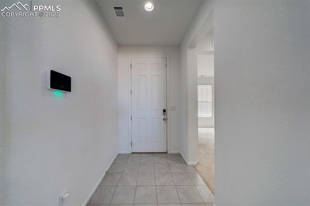 hallway featuring light tile patterned floors